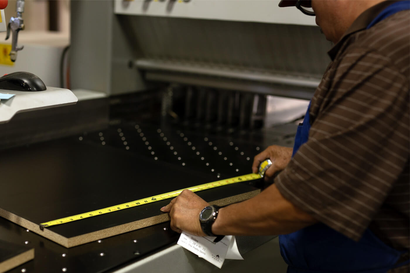 Pacific Panel employee measuring Cut to Size stock