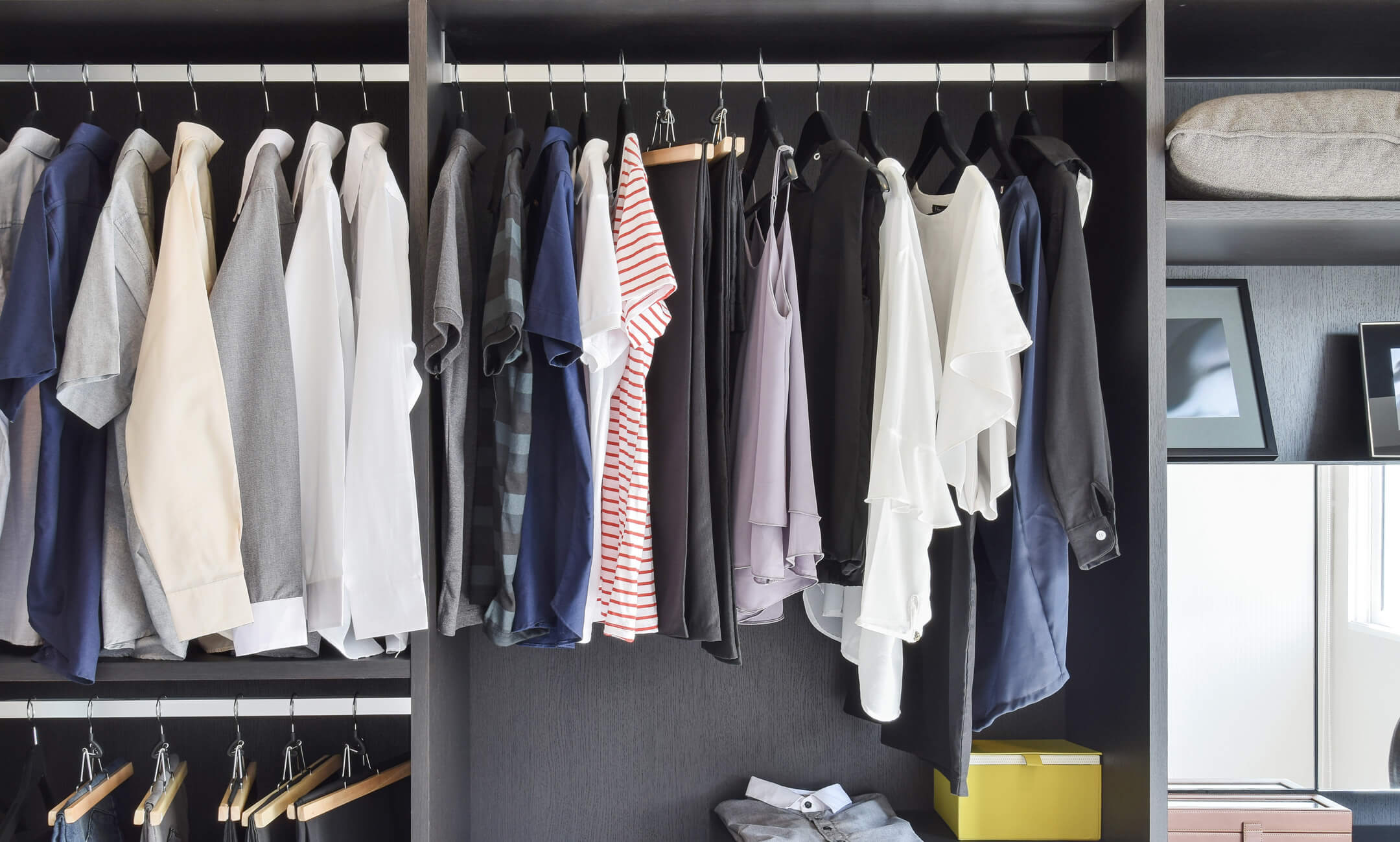 a closet with clothes on hangers